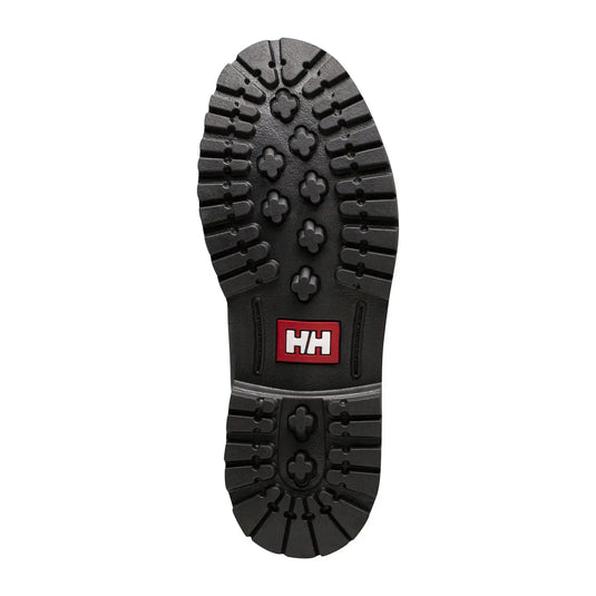 Eine Sohle eines Helly Hansen® Damen-Fremont-Lederstiefels mit Profilmuster und Markenlogo, entworfen für den Winter.