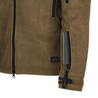 Nahaufnahme einer Helikon-Tex® Liberty Jacke – Double Fleece mit Reißverschlusstaschen und einem Stoff-Logo-Patch am Ärmel.
