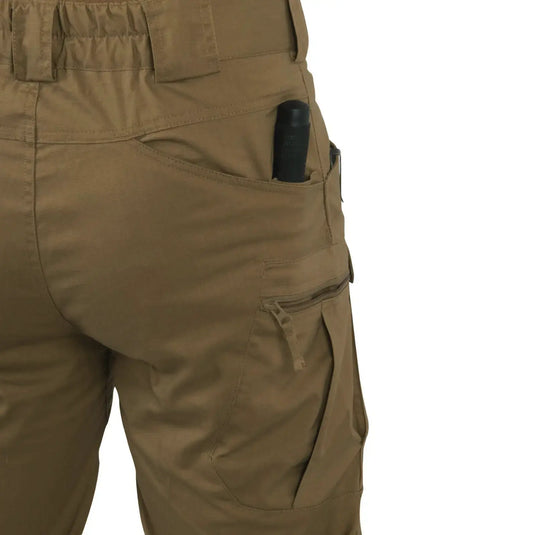 Nahaufnahme einer beigefarbenen Helikon-Tex® Urban Tactical Hose mit einem schwarzen Gegenstand in der Tasche.
