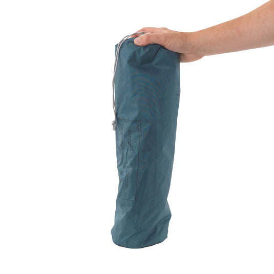 Eine Person hält einen gefalteten Campingstuhl Robens® TARP 3 x 3 m in einer Tasche vor weißem Hintergrund.