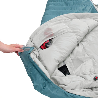 Person, die den Reißverschluss eines Robens® Schlafsack Gully 300 +4°C öffnet und dabei die darin enthaltene Kameraausrüstung zum Vorschein bringt.