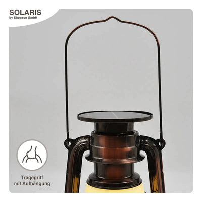 Solaris LED-Solarlaterne im Vintage-Stil mit Tragegriff und Klarglaskammer, gebrandet „solaris by shopco gmbh“.